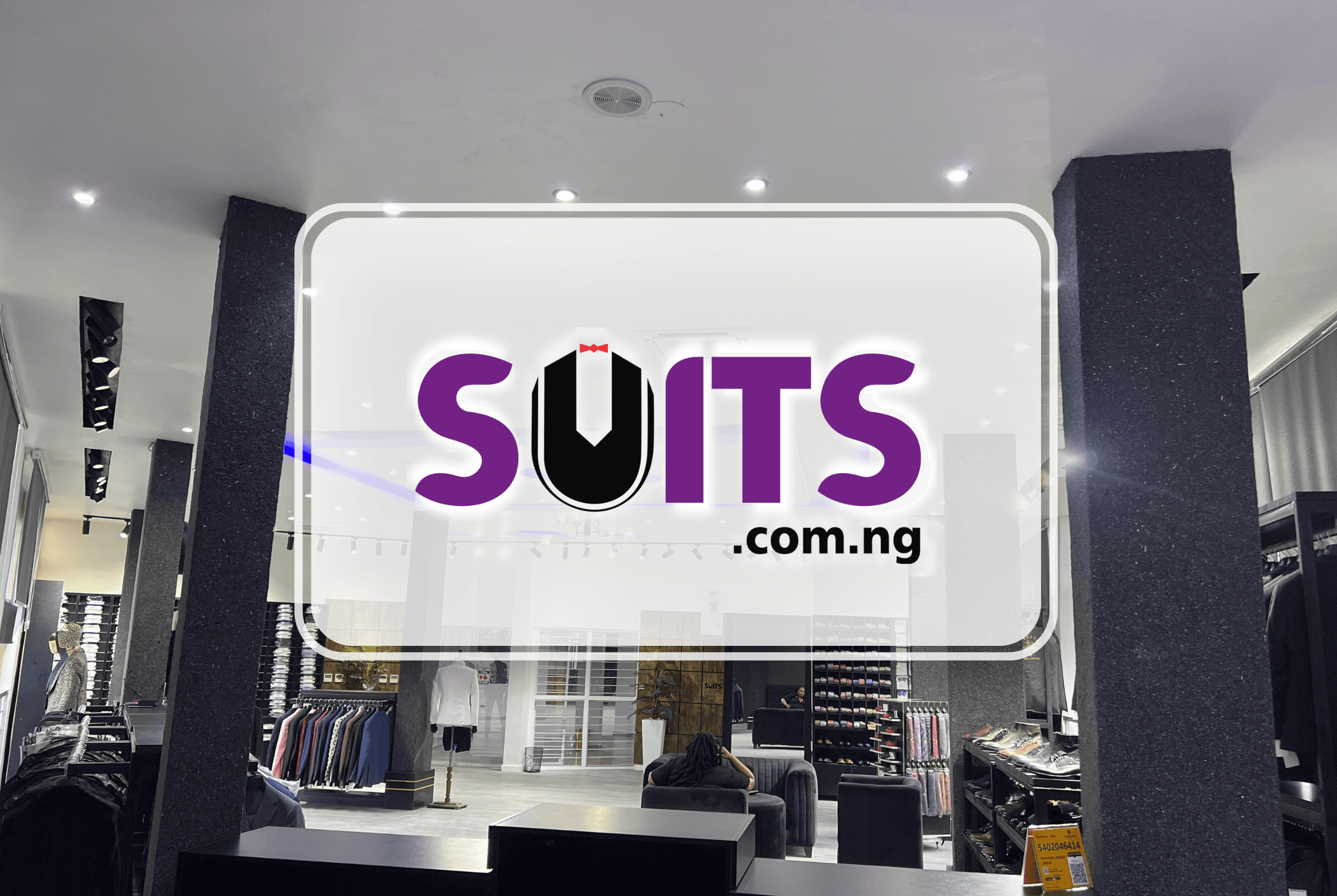 A woman showcasing formal suits at a clothing store