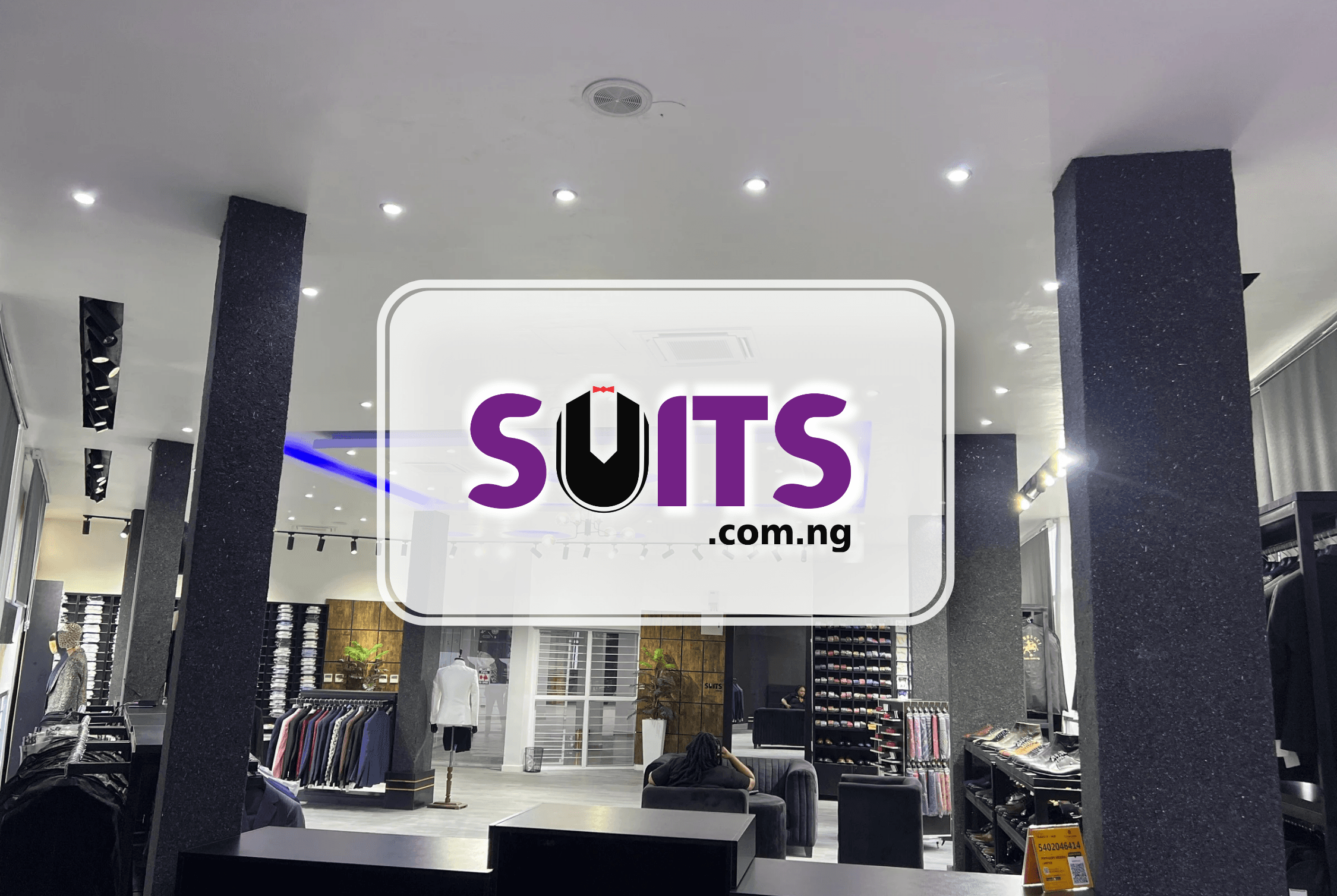 A woman showcasing formal suits at a clothing store